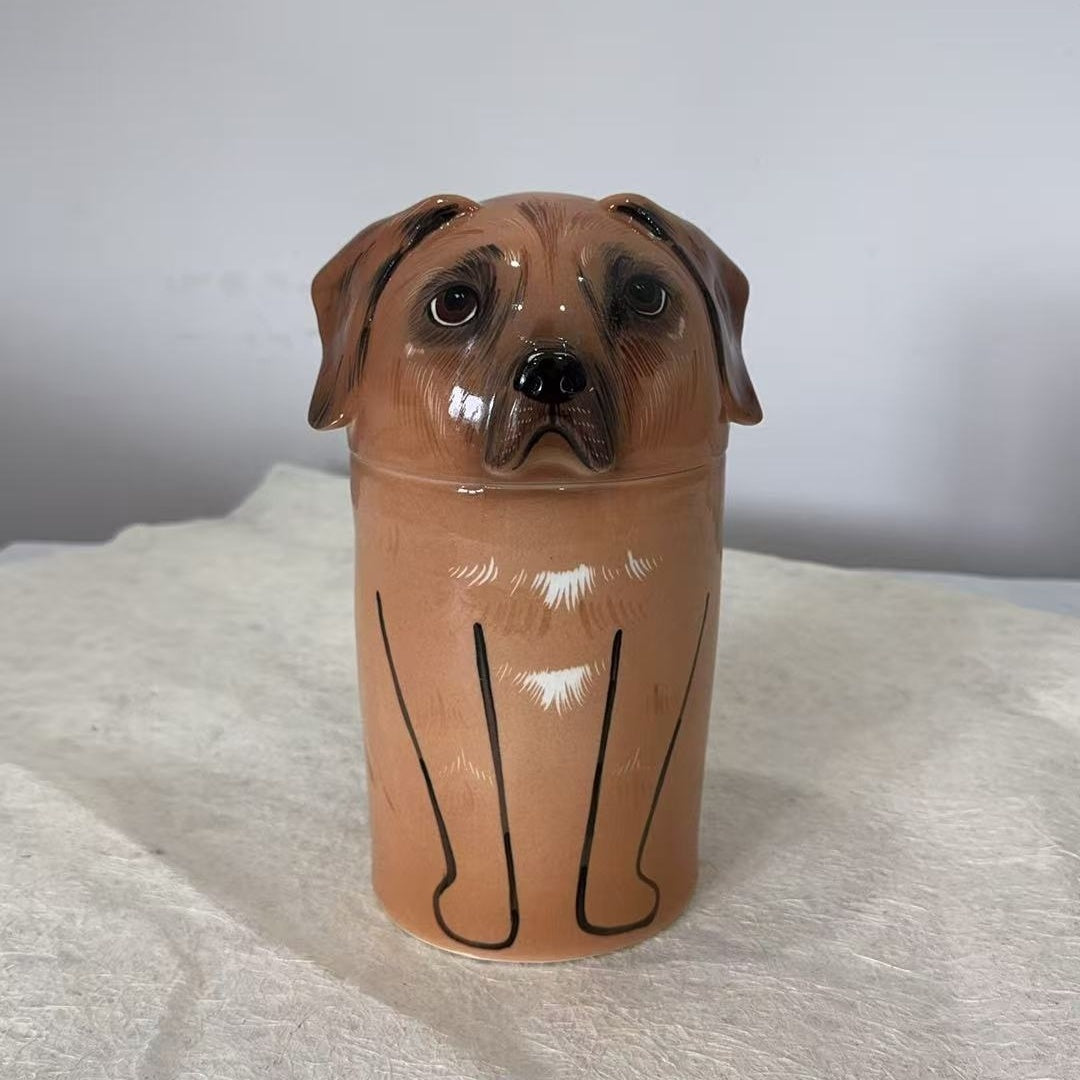 Ceramic jar shaped like a dog's head on a white surface with a light gray background