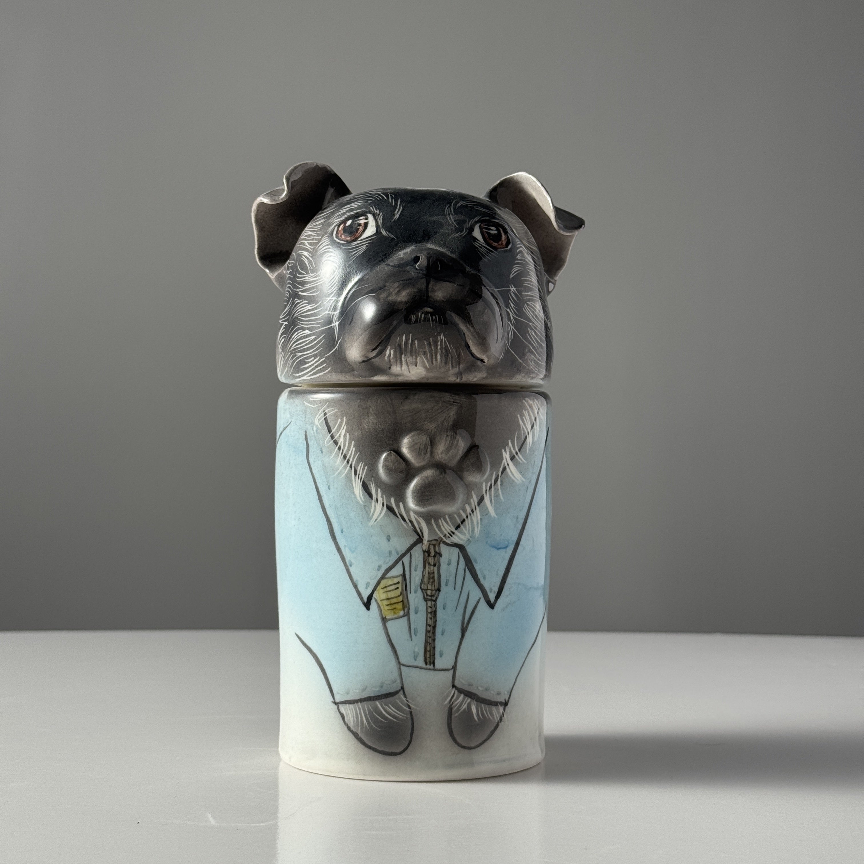 Ceramic jar with a dog design on a gray background