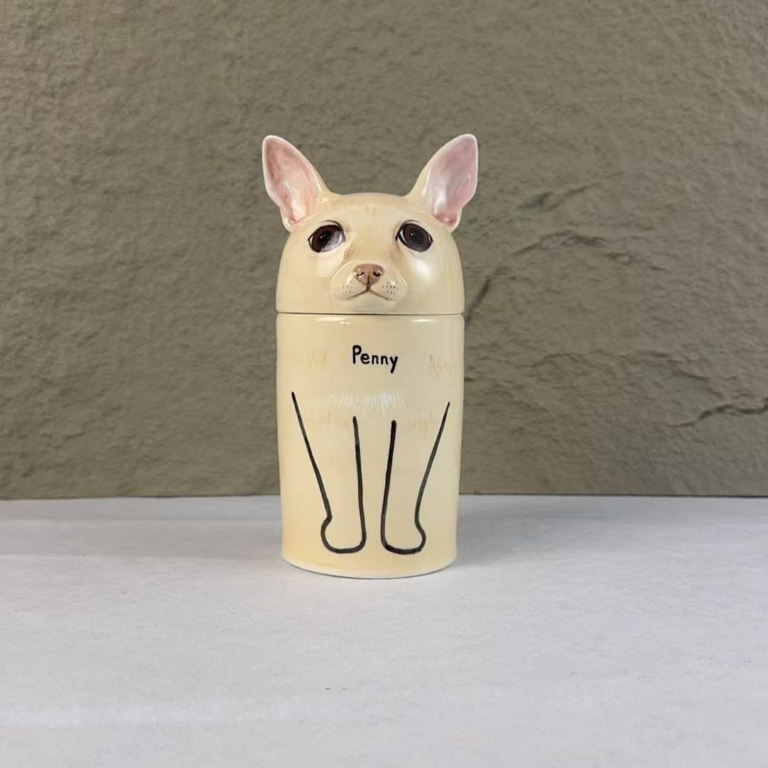 The ceramic container is shaped like a dog and has "Penny" written on it, a miniature Chihuahua.