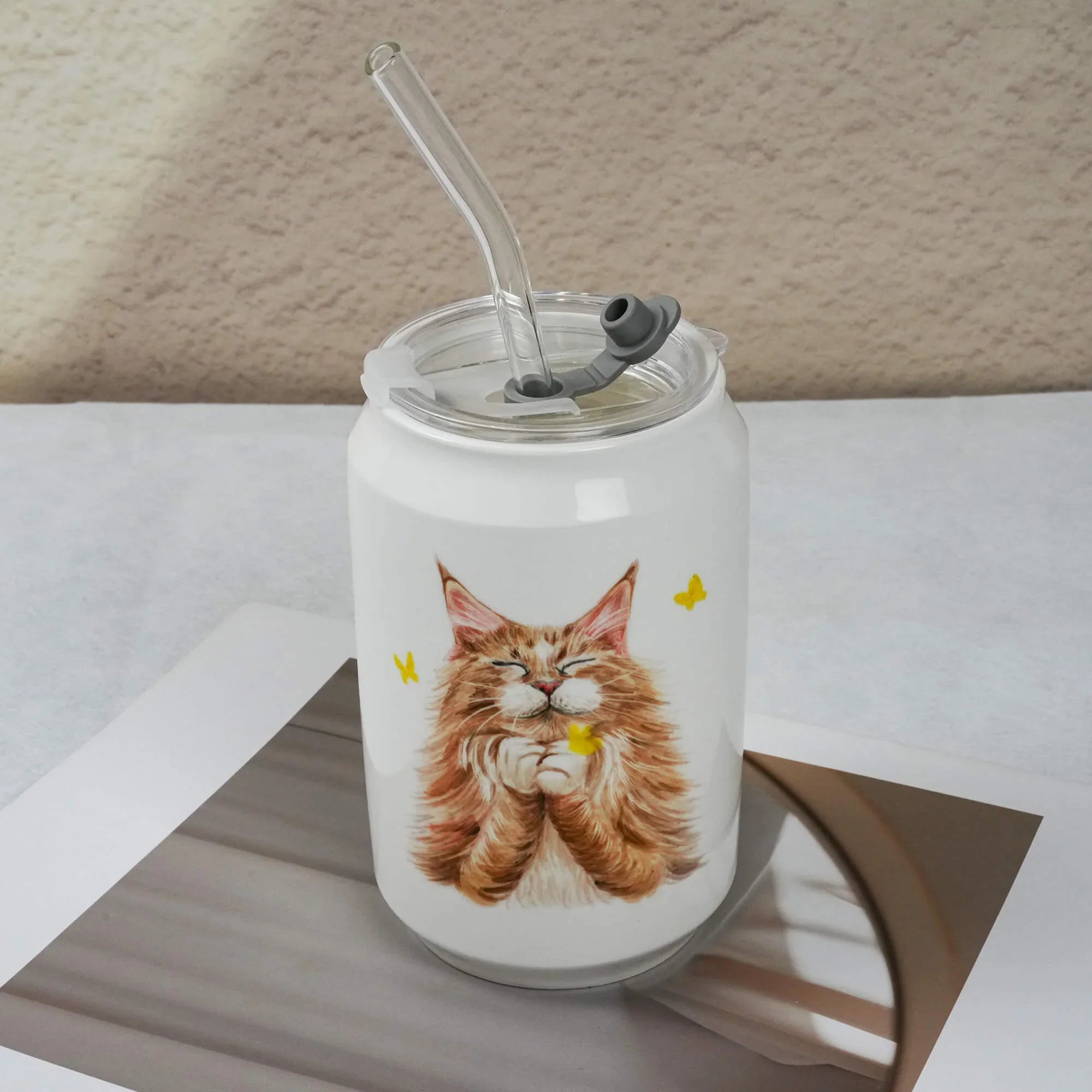 Tumbler with a cat design on a white surface