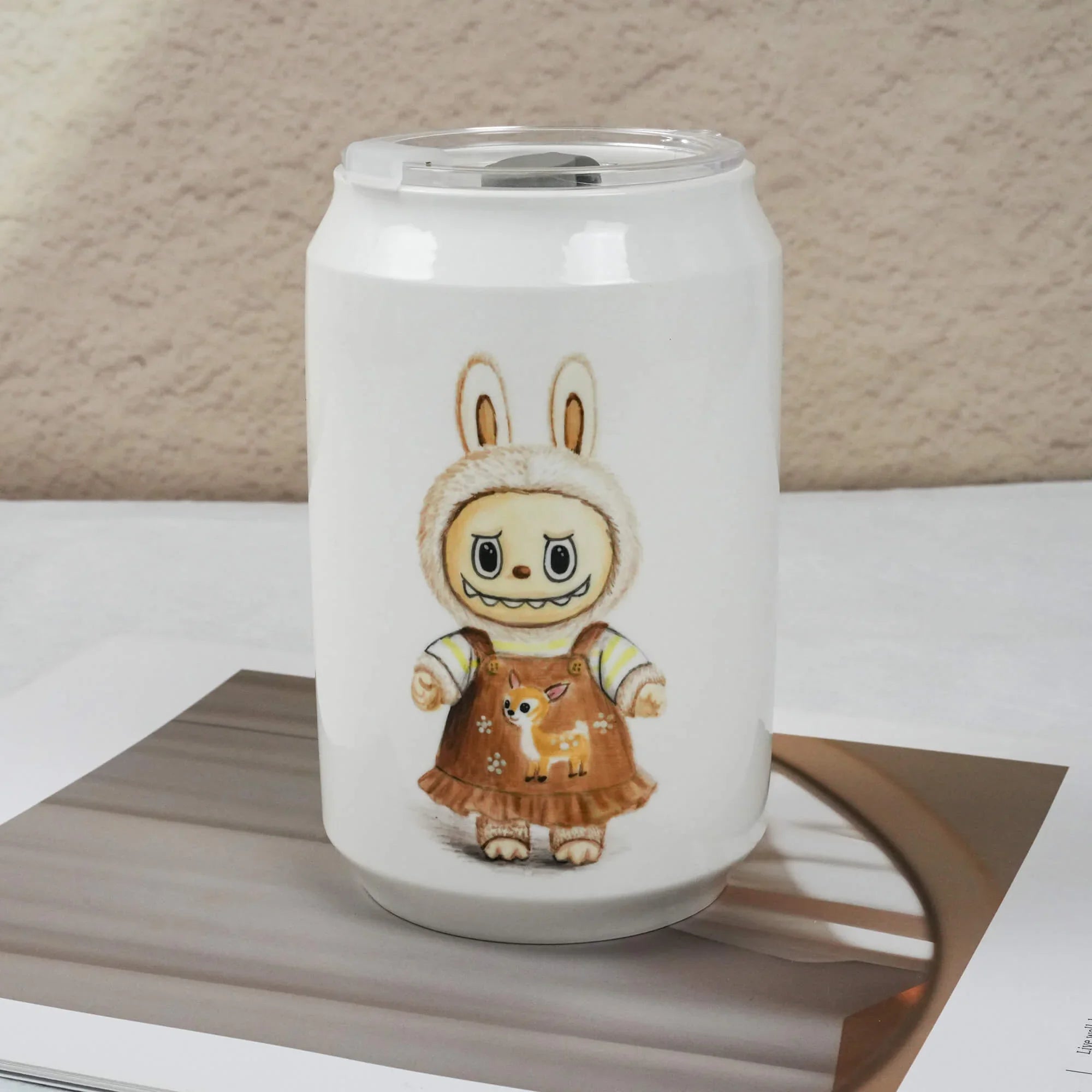 White mug with a cartoon character design on a wooden surface