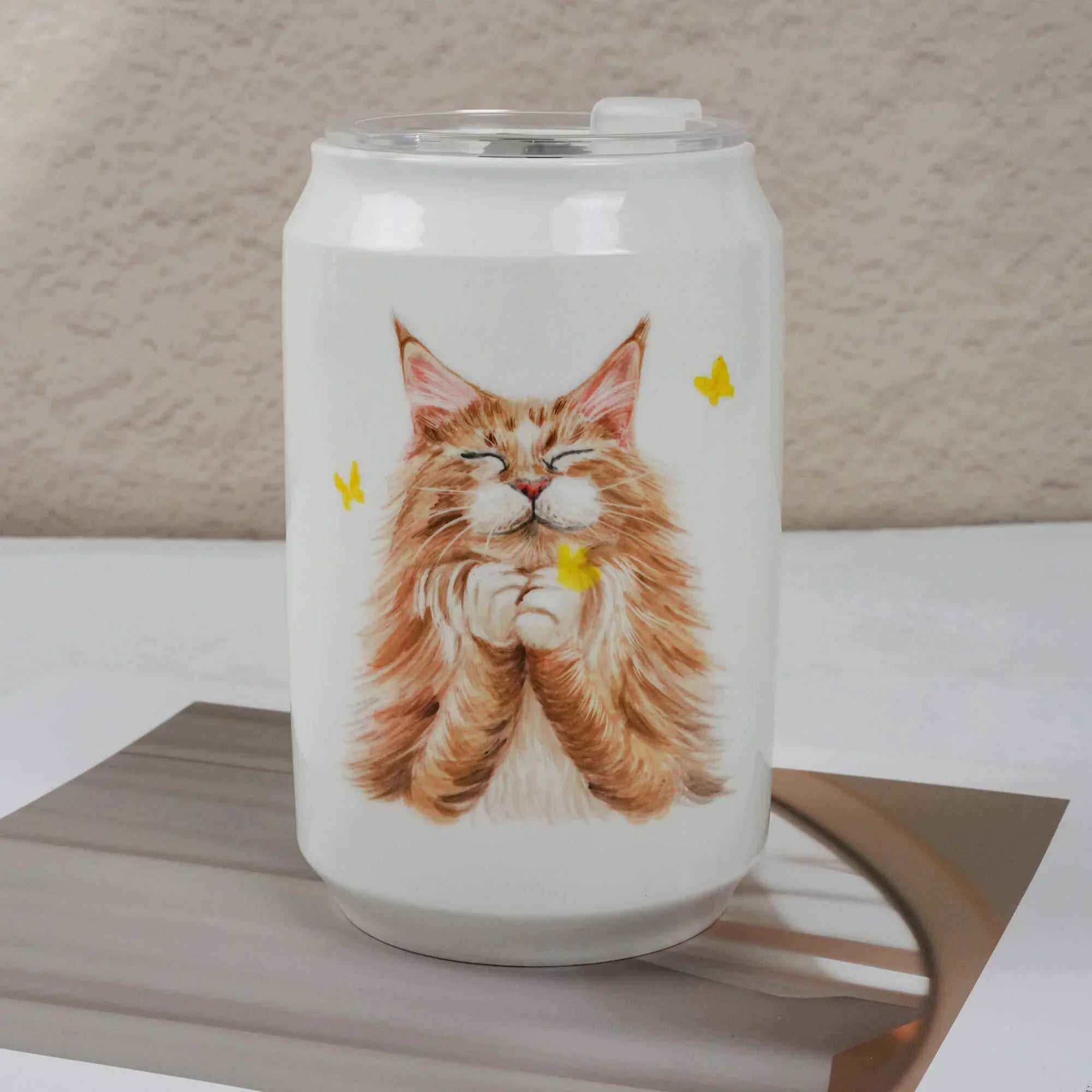 Tumbler with a cat illustration on a neutral background
