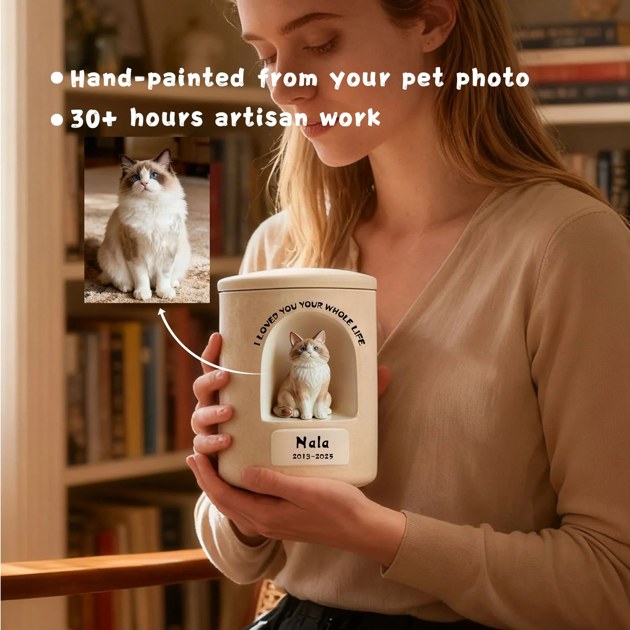 Person holding a personalized cat urn with a hand-painted pet photo on a bookshelf background