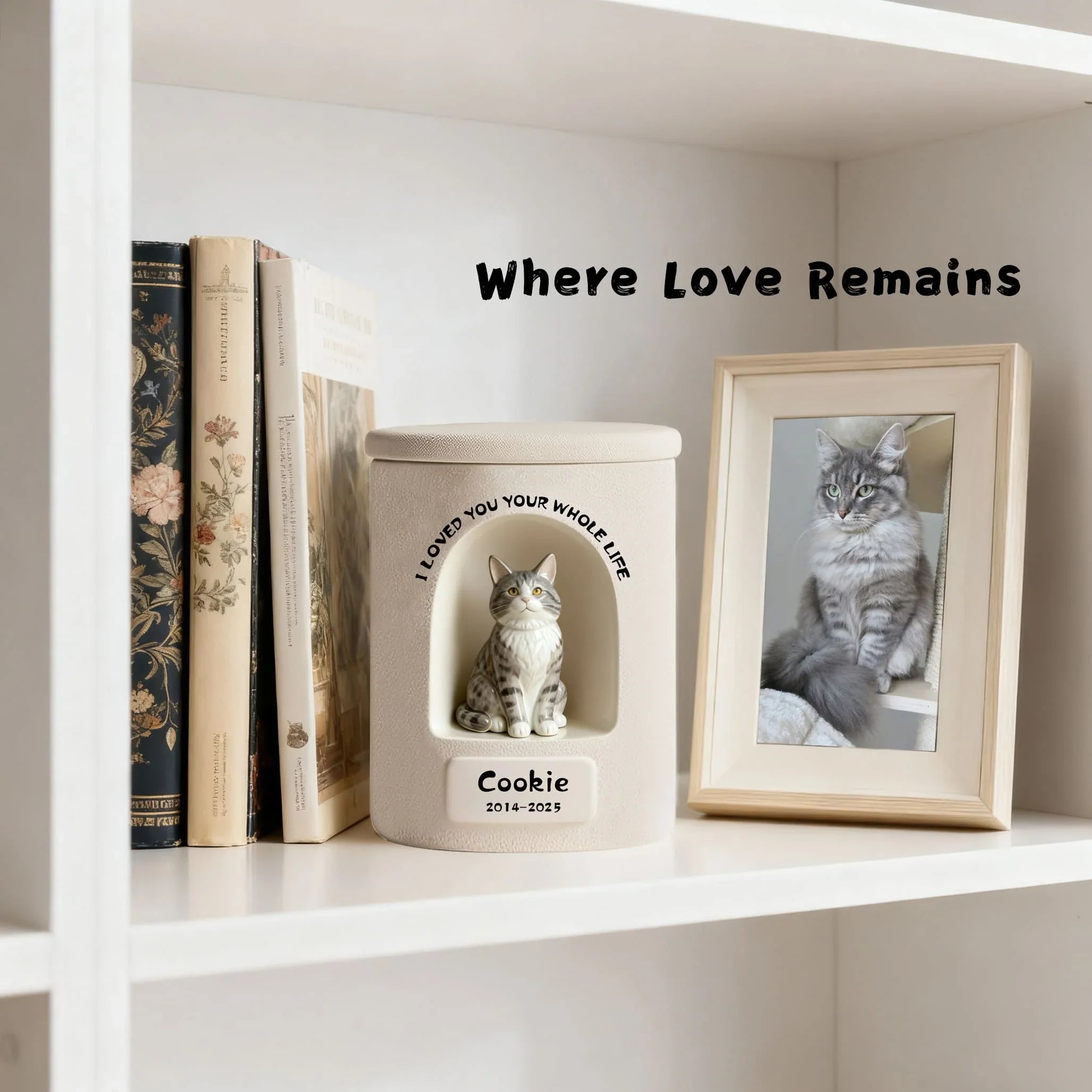 Shelf with a cat memorial book and framed photo of a cat named 'Cookie'.